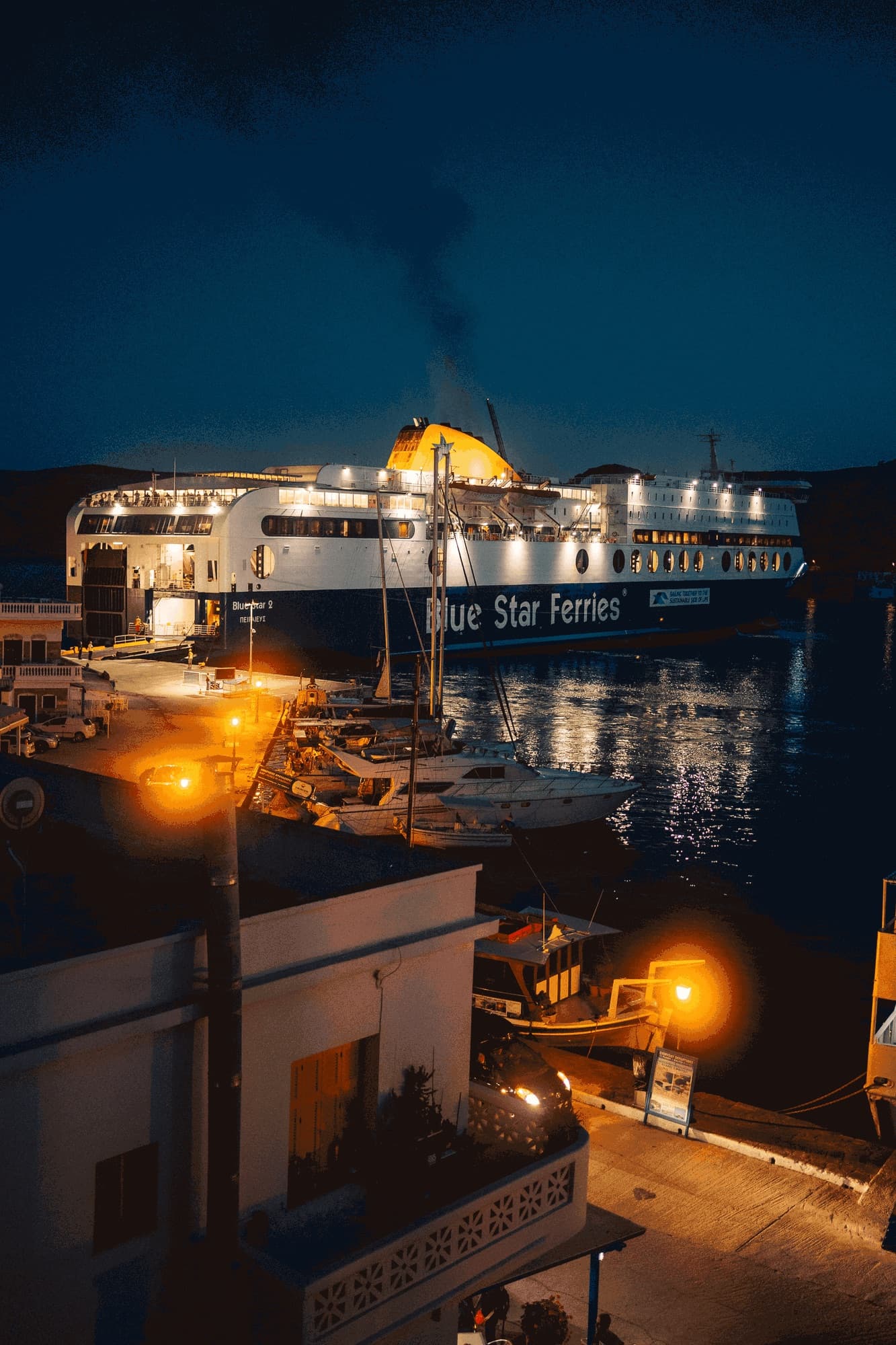 Ferry docked in a small harbour at night