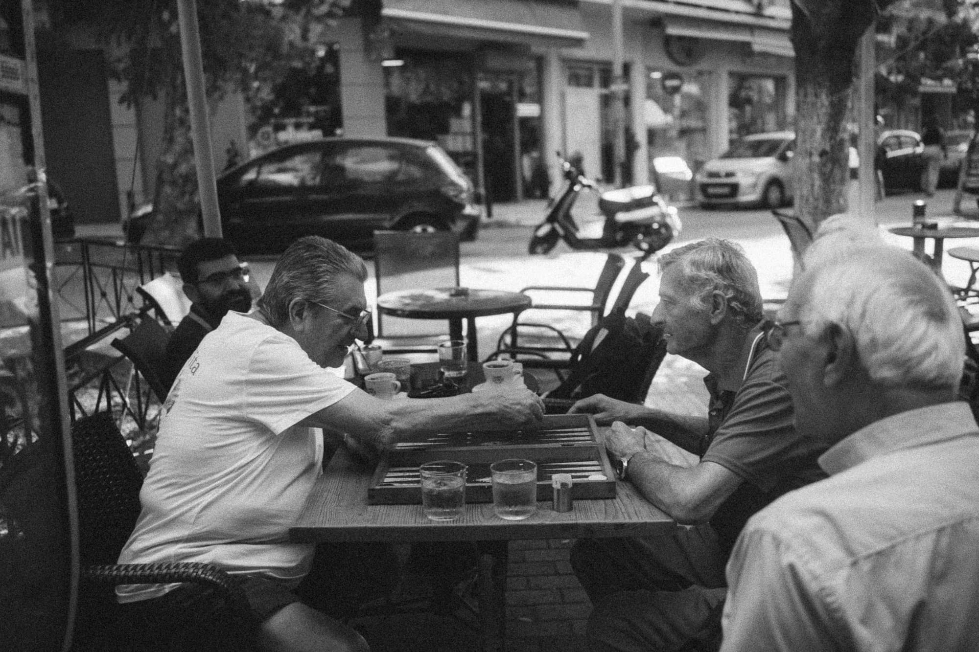 Men playing backgammon at a street café